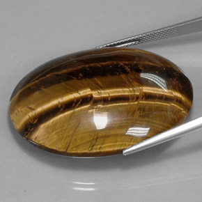 Натуральный коричневый tiger's eye 73,05 карата огранка овал, непрозрачный