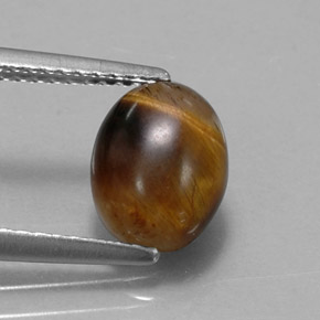 Натуральный коричневый tiger's eye 1,55 карата огранка овал, непрозрачный