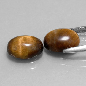 Натуральный коричневый tiger's eye  карата огранка овал, непрозрачный