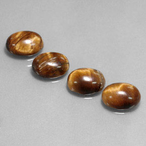 Натуральный коричневый tiger's eye  карата огранка овал, непрозрачный