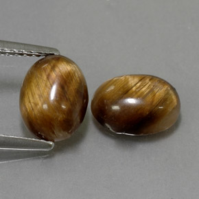 Натуральный коричневый tiger's eye  карата огранка овал, непрозрачный