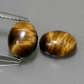 Натуральный коричневый tiger's eye  карата огранка овал, непрозрачный