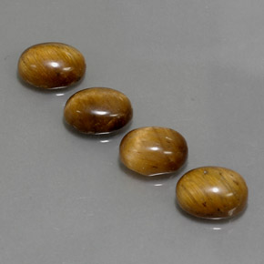 Натуральный коричневый tiger's eye  карата огранка овал, непрозрачный