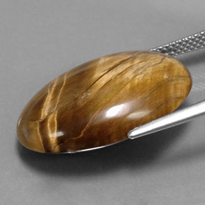 Натуральный коричневый tiger's eye 17,34 карата огранка овал, непрозрачный