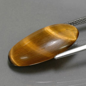 Натуральный коричневый tiger's eye 11,94 карата огранка овал, непрозрачный