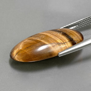 Натуральный коричневый tiger's eye 11,79 карата огранка овал, непрозрачный