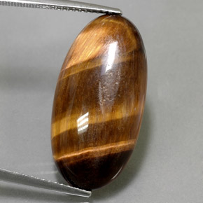 Натуральный коричневый tiger's eye 13,84 карата огранка овал, непрозрачный