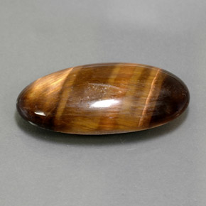 Натуральный коричневый tiger's eye 13,84 карата огранка овал, непрозрачный