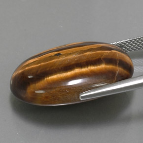 Натуральный коричневый tiger's eye 25,04 карата огранка овал, непрозрачный