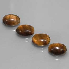 Натуральный коричневый tiger's eye  карата огранка овал, непрозрачный