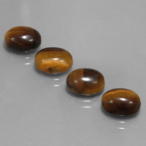Натуральный коричневый tiger's eye  карата огранка овал, непрозрачный