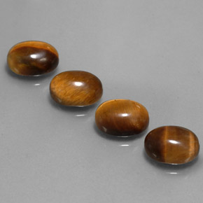 Натуральный коричневый tiger's eye  карата огранка овал, непрозрачный