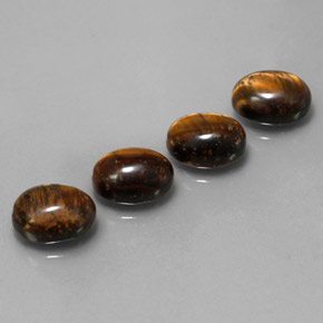 Натуральный коричневый tiger's eye  карата огранка овал, непрозрачный