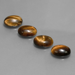 Натуральный коричневый tiger's eye  карата огранка овал, непрозрачный