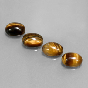 Натуральный коричневый tiger's eye  карата огранка овал, непрозрачный