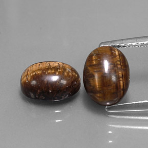 Натуральный коричневый tiger's eye  карата огранка овал, непрозрачный