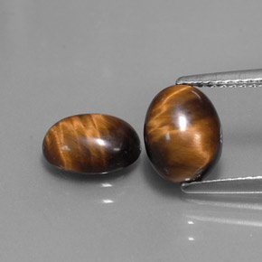 Натуральный коричневый tiger's eye  карата огранка овал, непрозрачный