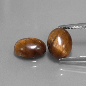 Натуральный коричневый tiger's eye  карата огранка овал, непрозрачный