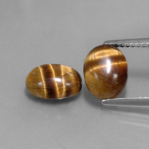 Натуральный коричневый tiger's eye  карата огранка овал, непрозрачный