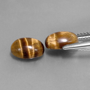 Натуральный коричневый tiger's eye  карата огранка овал, непрозрачный