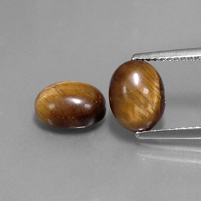 Натуральный коричневый tiger's eye  карата огранка овал, непрозрачный
