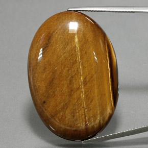 Натуральный коричневый tiger's eye 68,47 карата огранка овал, непрозрачный