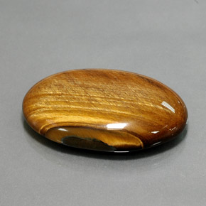 Натуральный коричневый tiger's eye 68,47 карата огранка овал, непрозрачный