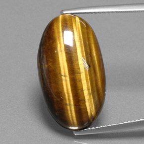 Натуральный коричневый tiger's eye 19,73 карата огранка овал, непрозрачный
