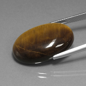 Натуральный коричневый tiger's eye 20,98 карата огранка овал, непрозрачный