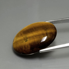 Натуральный коричневый tiger's eye 22,43 карата огранка овал, непрозрачный
