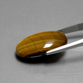 Натуральный коричневый tiger's eye 19,87 карата огранка овал, непрозрачный