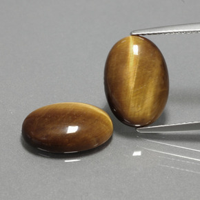 Натуральный коричневый tiger's eye  карата огранка овал, непрозрачный