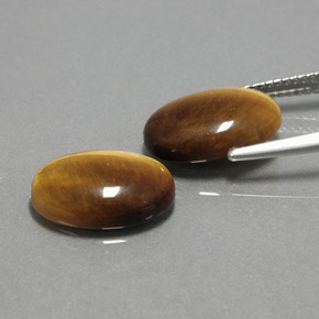 Натуральный коричневый tiger's eye  карата огранка овал, непрозрачный
