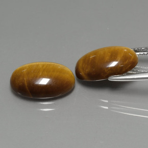 Натуральный коричневый tiger's eye  карата огранка овал, непрозрачный