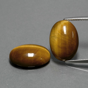 Натуральный коричневый tiger's eye  карата огранка овал, непрозрачный