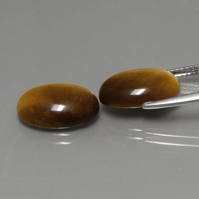 Натуральный коричневый tiger's eye  карата огранка овал, непрозрачный