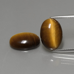 Натуральный коричневый tiger's eye  карата огранка овал, непрозрачный
